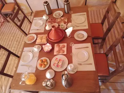 an overhead view of a table with plates of food at Merzouga Heart Luxury Camp in Merzouga