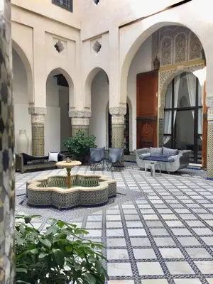 a courtyard with a fountain in the middle of a building at Riad Palais Bahia Fes in Fès