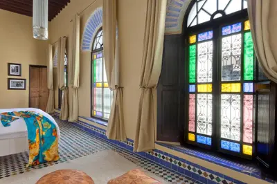 a room with stained glass windows and a bed at Riad Palais Bahia Fes in Fès