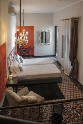 a bedroom with two beds and a couch in it at Riad Palais Bahia Fes in Fès
