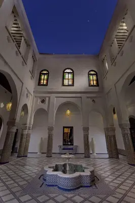 a large room with a fountain in the middle of a building at Riad Palais Bahia Fes in Fès