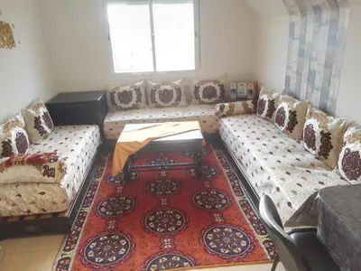 a living room with couches and a rug at maison Halima in Ifrane