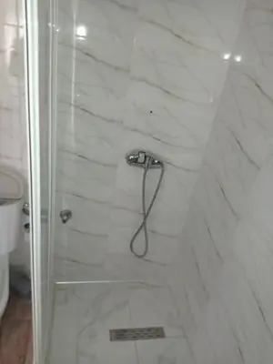 a shower with a shower head in a bathroom at maison Halima in Ifrane