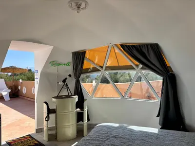 a bedroom with a large window in a room at Villa Roswell Marrakech in Marrakech
