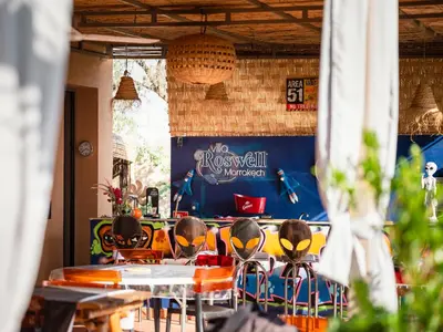 a group of tables and chairs in a restaurant at Villa Roswell Marrakech in Marrakech