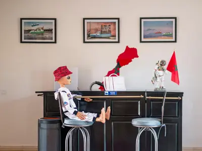 a doll sitting on a bar stool at a desk at Villa Roswell Marrakech in Marrakech