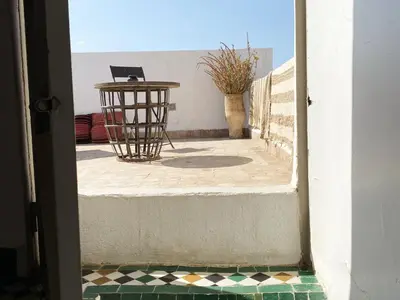 a table with a laptop sitting on top of a floor at Riad 9 Fez in Fès