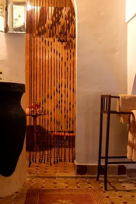 a room with a wooden wall with a wooden door at Riad 9 Fez in Fès