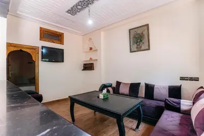 a living room with a couch and a table at The best apartments of Ourika valley in Setti Fatma
