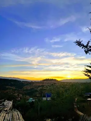 a view of the sunset from a roof at La belle vue Elmazini in Demnat