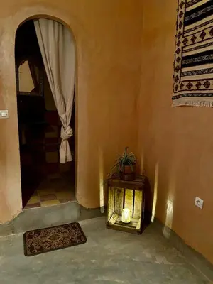 a room with a candle on a table with a window at Les chandelles in Tinerhir
