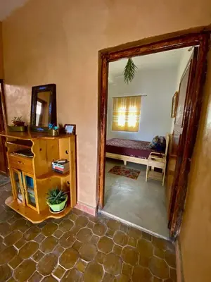 a room with a mirror and a dresser and a bedroom at Les chandelles in Tinerhir
