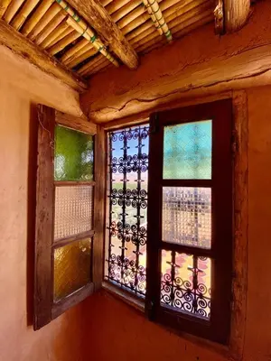 two windows in a room with a fence at Les chandelles in Tinerhir