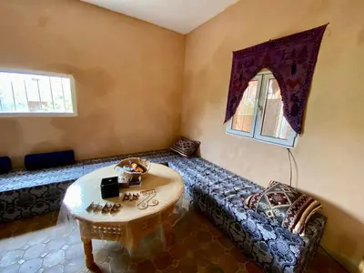 a living room with a couch and a table at Les chandelles in Tinerhir