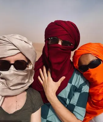 two women wearing hijab and sunglasses posing for a picture at Riad Dar Fadma in Ouarzazate