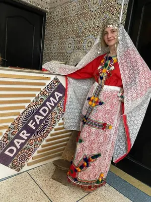 a woman dressed in a dress with a veil at Riad Dar Fadma in Ouarzazate