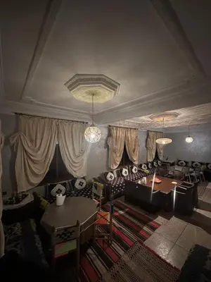 a living room with a couch and a table at Riad Dar Fadma in Ouarzazate
