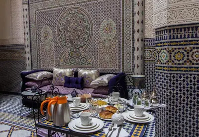 a living room with a table with food on it at Riad Taryana in Fès