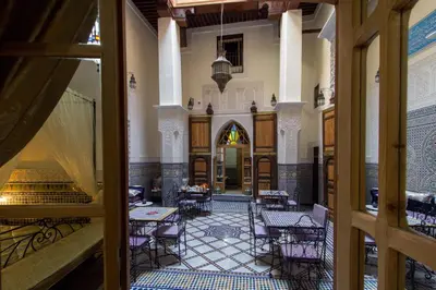 a view of a room with tables and chairs at Riad Taryana in Fès