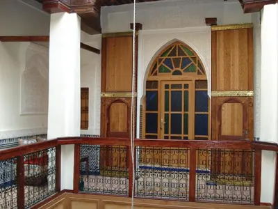 a balcony with a door and a stained glass window at Riad Taryana in Fès