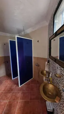 a bathroom with two sinks and a large mirror at auberge gite de jeunesse les Cascades in Setti Fatma