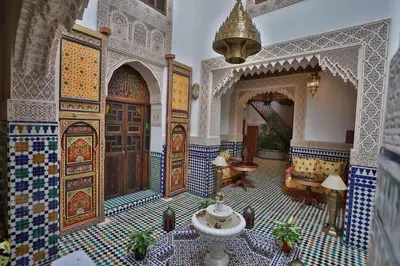 a large room with a large door and tile floors at Dar Hafsa in Fès