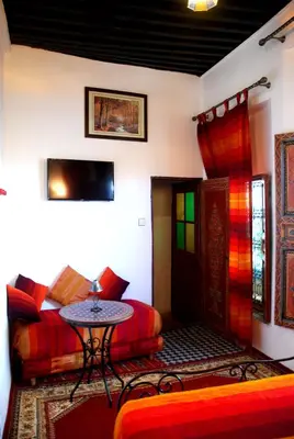 a living room with a couch and a table at Dar Hafsa in Fès