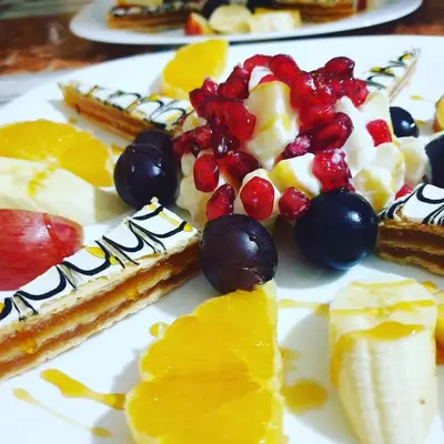 a plate of food with fruit on a table at Hôtel Restaurant La Gazelle De Dades in Akhendachou nʼAït Ouffi