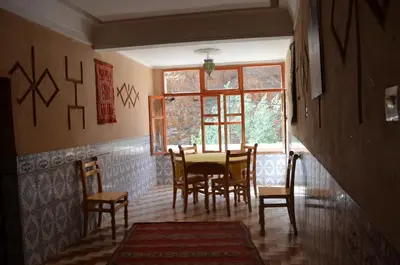 a dining room with a table and chairs and a window at Hôtel Restaurant La Gazelle De Dades in Akhendachou nʼAït Ouffi