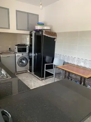 a kitchen with a stove and a refrigerator at Maison moalem in Marrakech