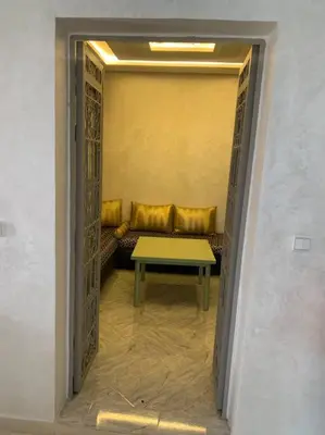 an entrance to a room with a couch and a table at Maison moalem in Marrakech