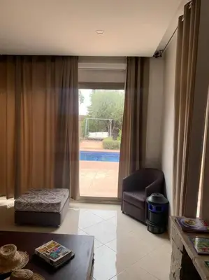 a living room with a couch and a window at Maison moalem in Marrakech