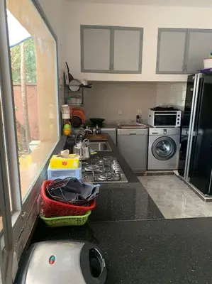a kitchen with a sink and a stove top oven at Maison moalem in Marrakech