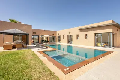 a swimming pool in the backyard of a house at Villa Sanna, élégante avec piscine Chauffée, jeux in Marrakech