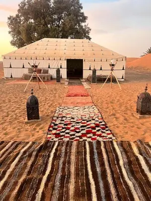 a large tent in the middle of a desert at Merzouga Prestige Camp in Merzouga