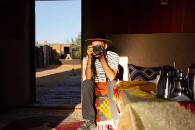 a man taking a picture of himself in a mirror at Camp Familia Erg Chebbi in Merzouga
