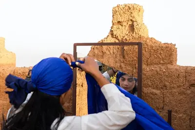 a group of girls working on a wall at Camp Familia Erg Chebbi in Merzouga