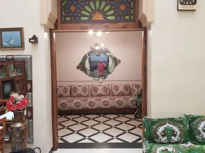 a living room with a mirror and a couch at Dar zerhane in Fès