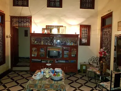 a living room with a table and a tv at Dar zerhane in Fès
