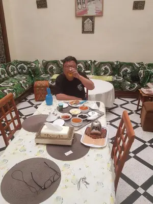 a man sitting at a table eating food at Dar zerhane in Fès