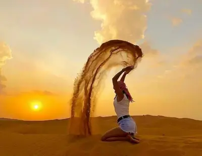 a woman in the desert with a piece of hair at Merzouga luxury magic nights in Merzouga