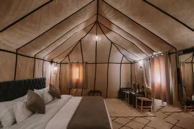 a bedroom with a bed in a tent at Merzouga Majestic Camp in Merzouga