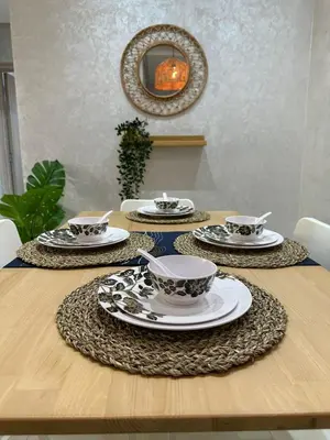a table with plates and dishes on it with a mirror at Ifrane apartment with swimming pool in Ifrane