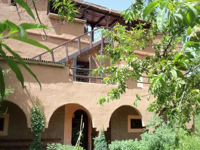 a building with a staircase on the side of it at Safranière du M' Goun in Aguerd nʼOuzrou