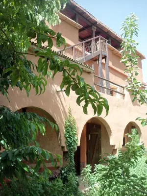 a building with a balcony on top of it at Safranière du M' Goun in Aguerd nʼOuzrou