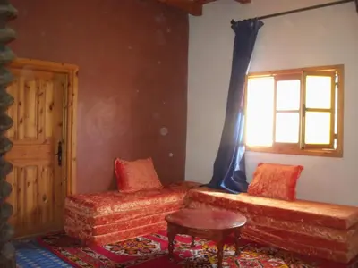 a living room with a couch and a window at Safranière du M' Goun in Aguerd nʼOuzrou