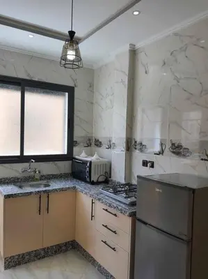 a kitchen with a sink and a stove in it at Appartement Dar Meknès in Meknès