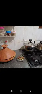 a kitchen counter with a stove and a plate of food at Chez-soi in Meknès
