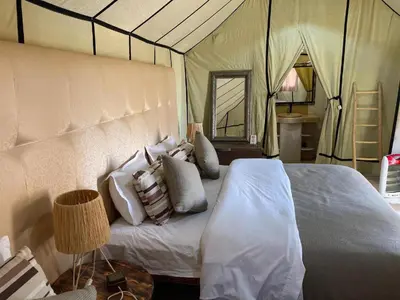 a bedroom with a bed in a tent at Arena Desert Camp & Activitys in Merzouga