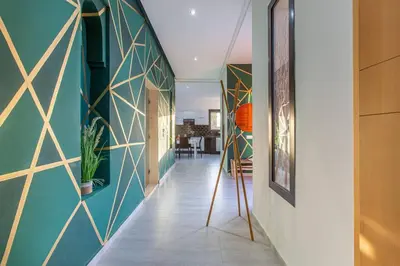 a hallway with green and gold tiled walls at villa Safa, confort et relax, piscine Chauffée, hammam in Marrakech